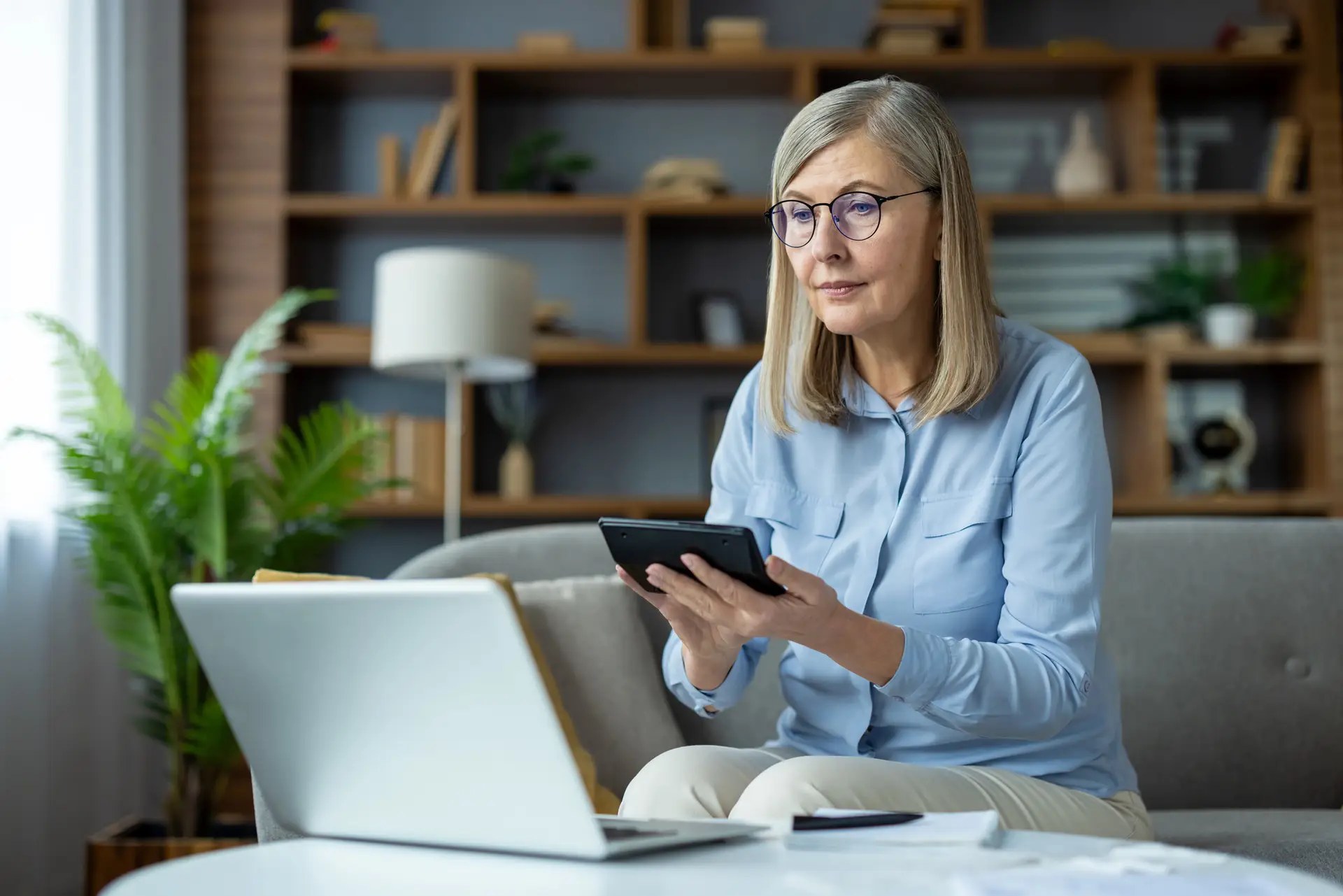 Older woman reviewing her bills at home