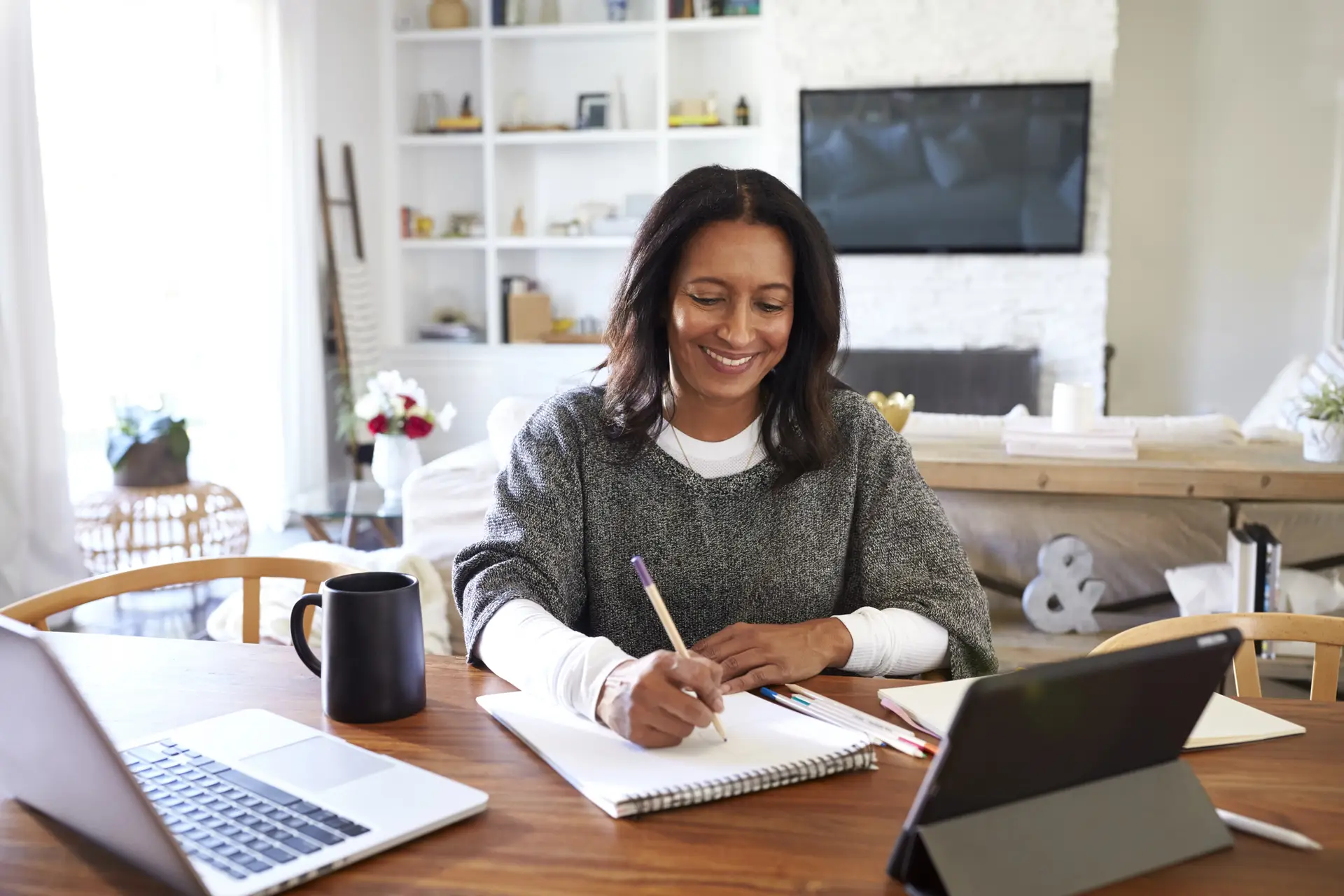 Woman shopping for health insurance on her laptop at home