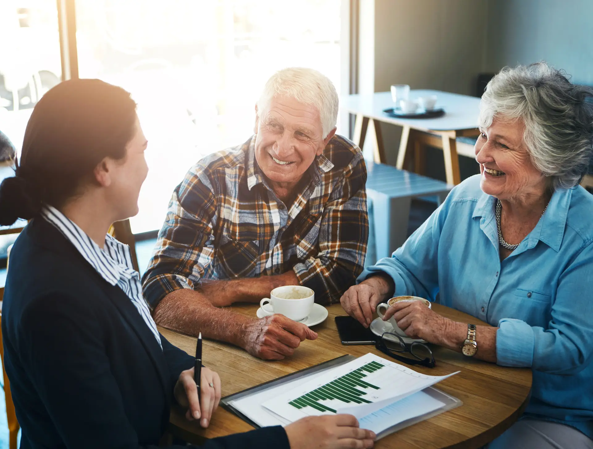 Older couple getting help with paperwork across a table