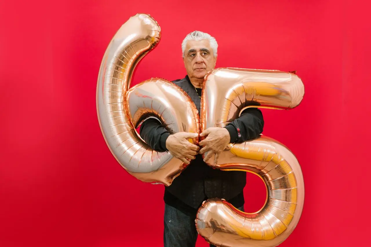 Man smiling at his birthday celebration with family